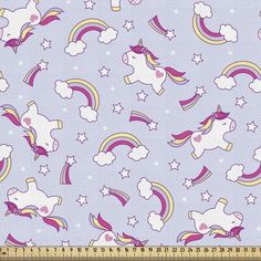 a blue fabric with unicorns and stars on it, as well as a ruler