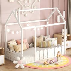 a child's bedroom with pink walls and white furniture