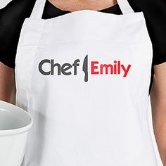 a woman in an apron holding a white bowl with the word chef emily on it