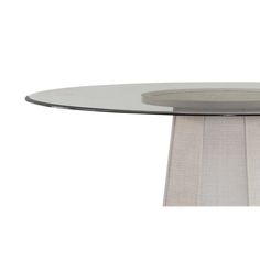 an oval glass table with metal base and white cloth around the edge, against a white background