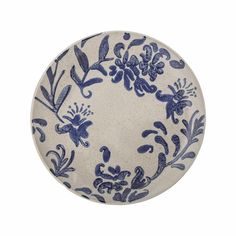 a blue and white plate with floral designs on the front, set against a white background