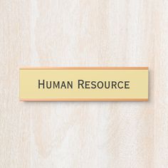 a wooden sign that says human resources on the side of a wood paneled wall