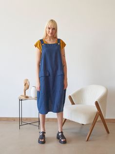 "PRODUCED in 3-5 days FAST & FREE shipping with DHL Express Courier -10% for all items with code \"FAVOURITE\" Made from prewashed and soft linen, this navy overall comes in dialogue with many different tops. Feel stylish in a natural way! Details: - 100% Linen - Pure linen fabric - Adjustable straps - Two front flap pockets - Side buttons closure - Below-knee length - Comfortable relaxed fit - Model's height is 178 cm / 5'10'' wears size M - Code: E9047-L532-152 The overall is available in other colors. You can find them in the gallery. If you want to order the overall in another color, please specify it in the personalization field. Sizing: This garment is true to size, and we recommend choosing the size you usually wear. If you want the garment to be loose-fitting, choose a larger size Blue Cotton Pinafore Dress With Pockets, Summer Bib Front Dress With Pockets, Casual Bib Front Dress With Pockets, Casual Dresses With Bib Front And Pockets, Blue Linen Dress With Pockets, Sleeveless Linen Overalls, Sleeveless Linen Overalls With Pockets, Womens Overalls, Navy Linen