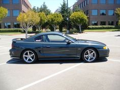 a black sports car parked in a parking lot