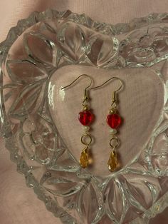 Handmade dangly earrings featuring a red heart and amber wire-wrapped crystal. (Right pair in 3rd pic). Wrapped Crystal, Wire Wrapping Crystals, Dangly Earrings, May 5, Bead Earrings, Red Heart, Beaded Earrings, Wire Wrapped, Wire Wrapping