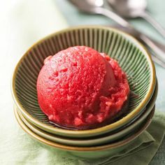 a red dessert in a bowl on top of two plates