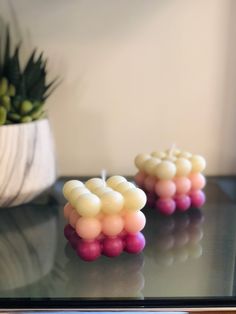 two small candles are sitting on a table