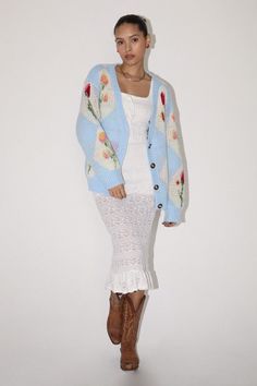 Add a touch of whimsy to your wardrobe with our Fleur Diamond and Flower Knit Cardigan! This sky blue sweater features delicate diamond stitching and colorful flowers, making it the perfect playful addition to any outfit. The bright colors are perfect for layering on any outfit for Spring. Stay cozy and stylish at the same time with this charming cardigan.