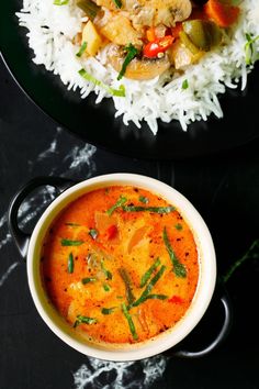 there is a bowl of soup and rice on the table