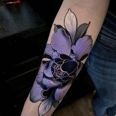 a person with a flower tattoo on their arm