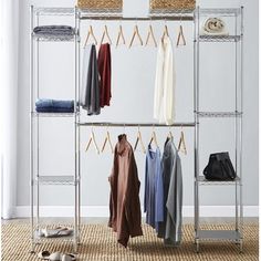 an organized closet with clothes and shoes hanging on the rack, next to a pair of slippers