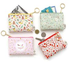 four small purses are lined up on a white surface, one has a coin in it