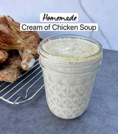 homemade cream of chicken soup in a glass jar next to some meat on a rack