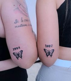 two women with matching tattoos on their arms