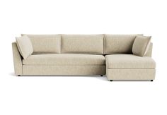 a beige sectional couch sitting on top of a white floor