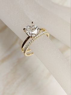 a diamond ring sitting on top of a white piece of paper