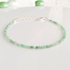 "Minimalist, wearable and delicate 925 sterling silver green emerald bracelet for everyday wearing. Length: from 5,5\" to 8\" with 2\" 925 sterling silver extensor chain. Width: 2 mm 925 sterling silver beads and green emerald beads. Material: 925 sterling silver strong lobster clasp. Handmade in Spain. ✩ Please kindly note that these stones are natural so they can vary slightly in color from the one on the pics. They can also contain some inclusions. ✩ Ideal for a gift to silver jewelry lovers. Green Emerald Bracelet, Layered Bracelet, Emerald Bracelet, Gold Armband, Emerald Bead, Birthstone Bracelet, Bracelet Crystal, Bracelet Dainty, May Birthstone