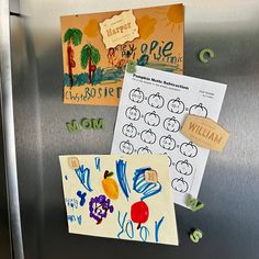 the refrigerator door is covered with magnets and paper crafts for children to draw on