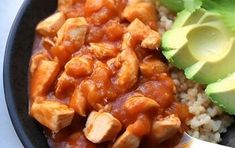 a bowl filled with rice, meat and avocado