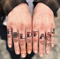 Learn all about finger tattoos: Healing, pros and cons, tips, design options, and a list of four letter words. Finger Name Tattoo, Finger Letter Tattoos, Hold Fast Tattoo, Love Finger Tattoo, Finger Tattoos Words, Calligraphy Tattoo Fonts, Tattoo Lettering Fonts