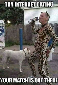 a man in leopard print jumpsuit drinking from a bottle next to a white dog