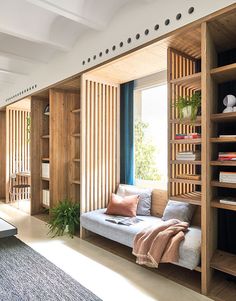 a living room filled with furniture and bookshelves