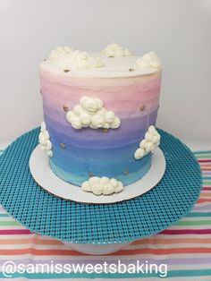 a multi - colored cake with marshmallows on top