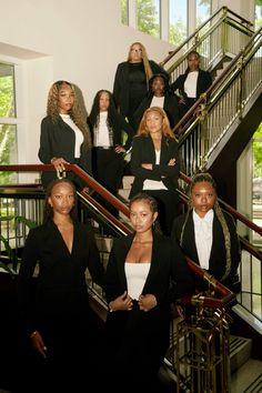 a group of women standing on top of stairs