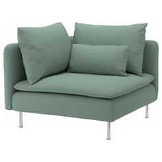 a green couch with two pillows on the back and one arm folded up to it's side