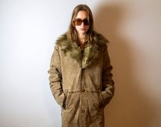 "A beautiful and extremely rare hippie coat made of chamois leather from the 90s. A long and very warm coat from Denmark, fastened with buttons. Two front pockets. Coat with decorative stitching. Thick warm layer from the bottom. There is an inscription on the label: the suede was given a \"jungle\" look. Shadings within panels with occur and this is not regarded as fault. Perfect vintage condition. Strong leather odor. Composition: 100% leather outside inner lining: acrylic and polyester Check 90s Hippie, Brown Leather Coat, Suede Coat, Warm Coat, Vintage Coat, Long Coat, Leather Coat, Vintage Leather, New Dress