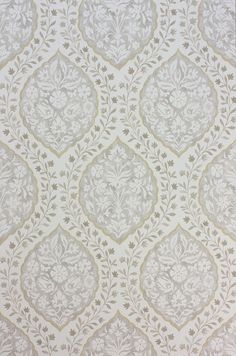 a white and gold wallpaper with an intricate design on it's surface,