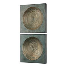 two square metal wall art pieces with circular designs on the sides, one in green and one in gold