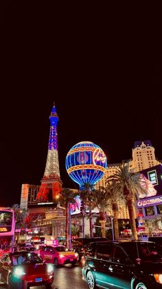 the eiffel tower is lit up at night