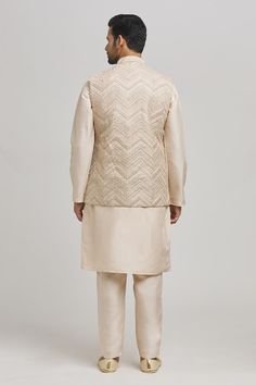 Ivory bundi with thread embroidered chevron patterns. Comes with inner kurta and pant. - Aza Fashions Beige Nehru Jacket With Traditional Drape For Festive Occasions, Beige Nehru Jacket For Festive Occasions, Festive Beige Nehru Jacket, Beige Bandhgala With Chikankari Embroidery In Raw Silk, Silk Nehru Jacket With Intricate Embroidery For Reception, Elegant Nehru Jacket With Gota Work For Festive Occasions, Beige Bandhgala With Chikankari Embroidery For Transitional Seasons, Festive Beige Bandhgala With Chikankari Embroidery, Off White Nehru Jacket With Zari Work