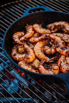 shrimp being cooked in a skillet on the grill