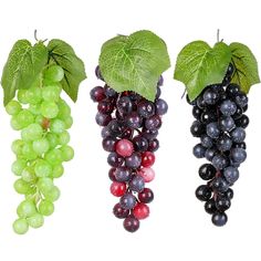 three bunches of grapes with green leaves