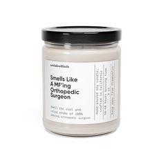 smells like a m - nag orthopedic surgeon candle in white jar with black lid