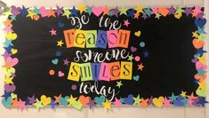 a bulletin board with the words be the reason someone smiles today written in multicolored stars