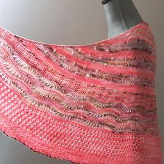 a close up of a knitted shawl on a mannequin