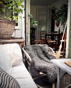 a living room filled with lots of furniture next to a wooden table and planter