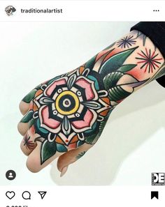 a person with tattoos on their arm and hand