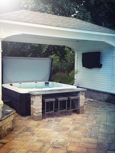 a hot tub sitting under a white roof