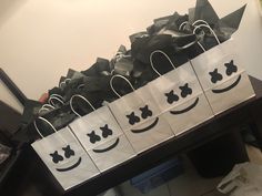 several bags with smiley faces on them sitting on a table