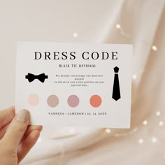 a person holding up a business card that says dress code