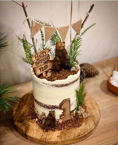 a birthday cake decorated with woodland animals and decorations