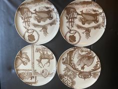 four brown and white plates with animals on them