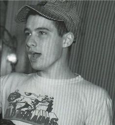 black and white photograph of a young man wearing a hat