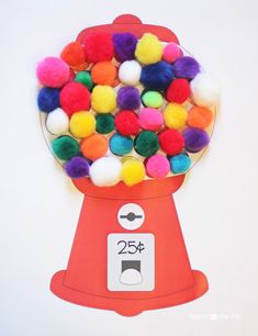 a gummy machine filled with lots of colorful pom - poms in front of a white background