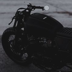 a black motorcycle is parked on the street