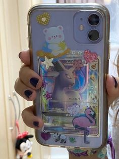 a girl holding up her phone case with stickers on it